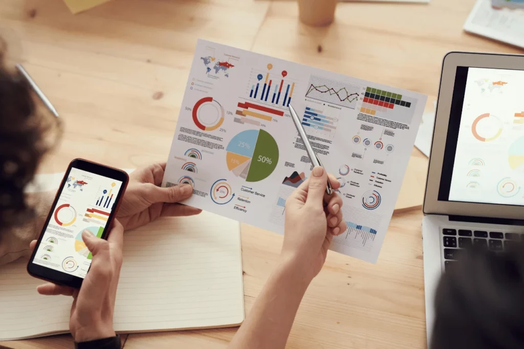 kağıt ve telefon ekranında gözüken grafik ve tablolar